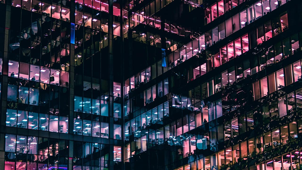 Office building windows lit up at night
