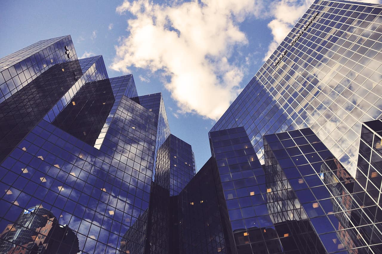Low-angle view of a modern glass office tower